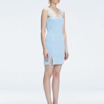 Side view of model showcasing the chic buckle accents and front slit on the Heather Baby Blue Mini Dress.
