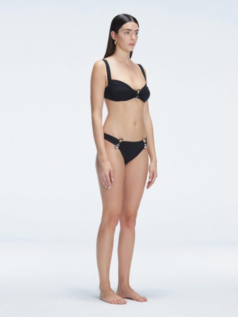 Side view of the Emilia Black Bikini Bottom, featuring moderate coverage and fully lined Italian fabric.
