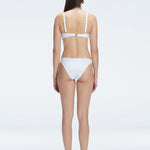 Back view of model wearing Emilia White Bikini Set , featuring adjustable straps and breathable mesh accents.
