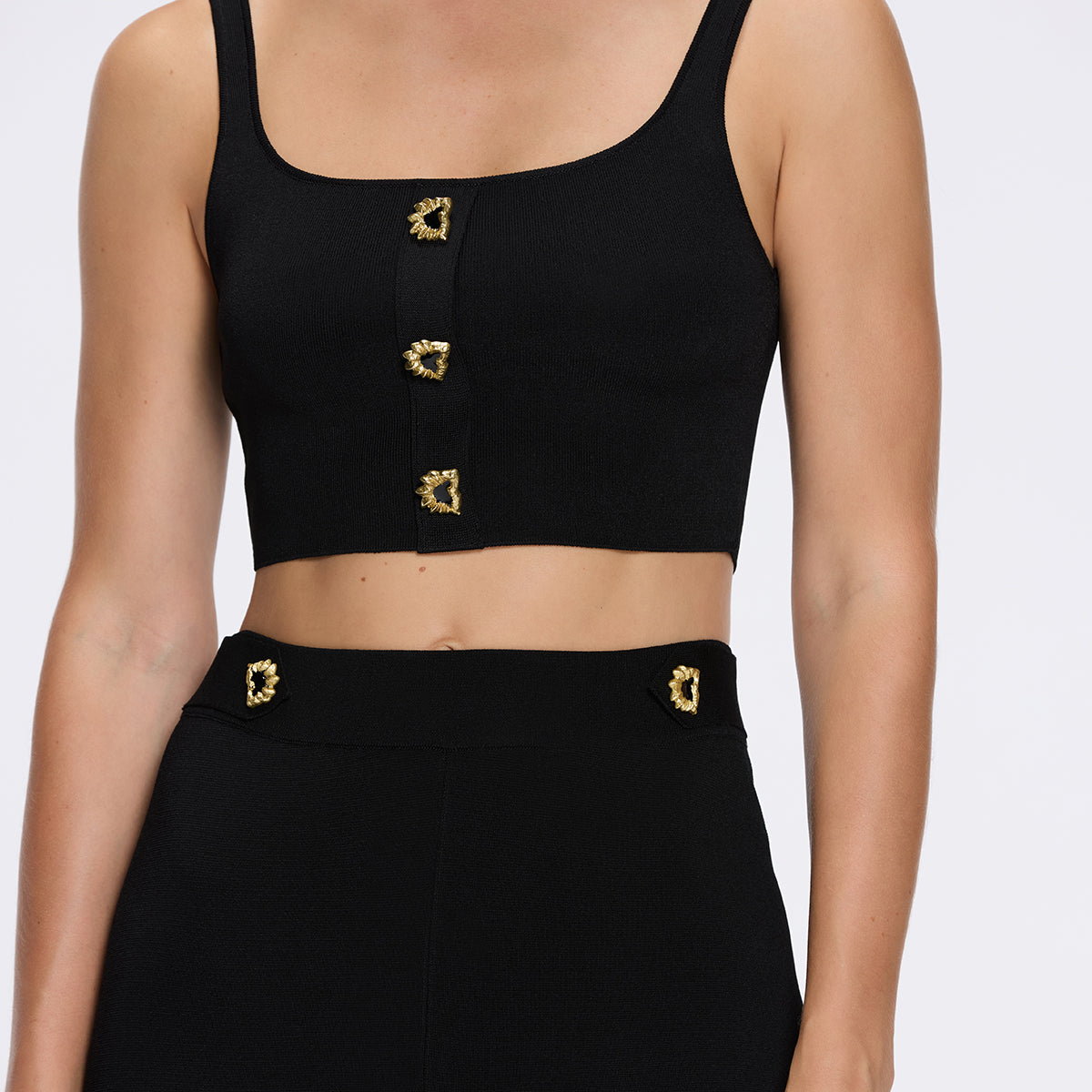 Aureline Black Knitted Scoop Neck Gold Buttoned Crop Top | Moeva | Crop Top | Each week unveils new pieces—luxury swimwear, fluid resort silhouettes, and elevated summer-to-evening essentials designed to carry you from coastal escapes to city nights.