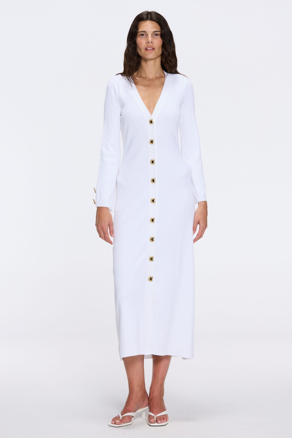 Brezia White Knitted Maxi Dress with Long Sleeves and Gold Button Details | Moeva | RTW Dresses | Each week unveils new pieces—luxury swimwear, fluid resort silhouettes, and elevated summer-to-evening essentials designed to carry you from coastal escapes to city nights.