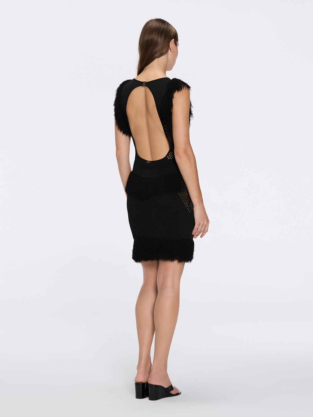 Diani Black Fringe Detail Sheer Panel Open Back Mini Dress | Moeva | RTW Dresses | Each week unveils new pieces—luxury swimwear, fluid resort silhouettes, and elevated summer-to-evening essentials designed to carry you from coastal escapes to city nights.