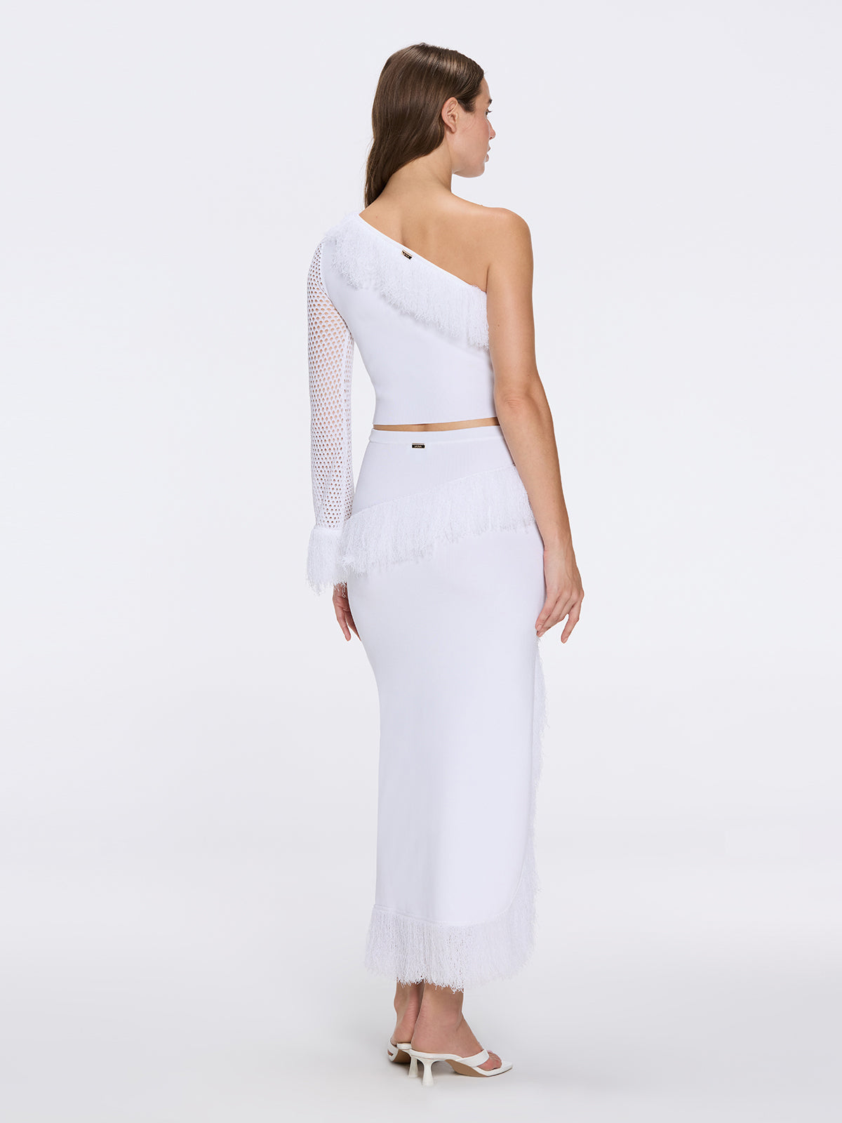 Monroe White One-Shoulder Knit Top with Fringe & Mesh Sleeve | Moeva | Crop Top | Each week unveils new pieces—luxury swimwear, fluid resort silhouettes, and elevated summer-to-evening essentials designed to carry you from coastal escapes to city nights.