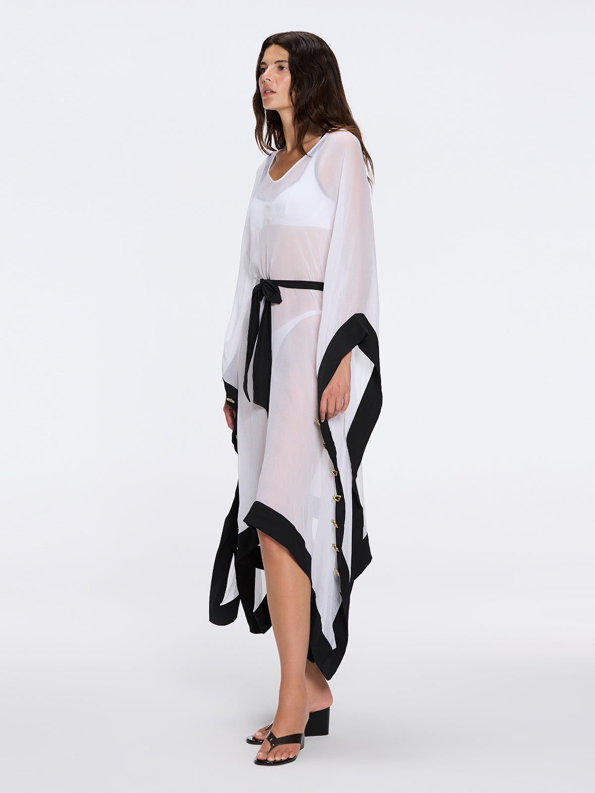 Tata White-Black Sheer Gold Buttoned Belted Kaftan with Asymmetric Hem | Moeva | Kaftan | Each week unveils new pieces—luxury swimwear, fluid resort silhouettes, and elevated summer-to-evening essentials designed to carry you from coastal escapes to city nights.