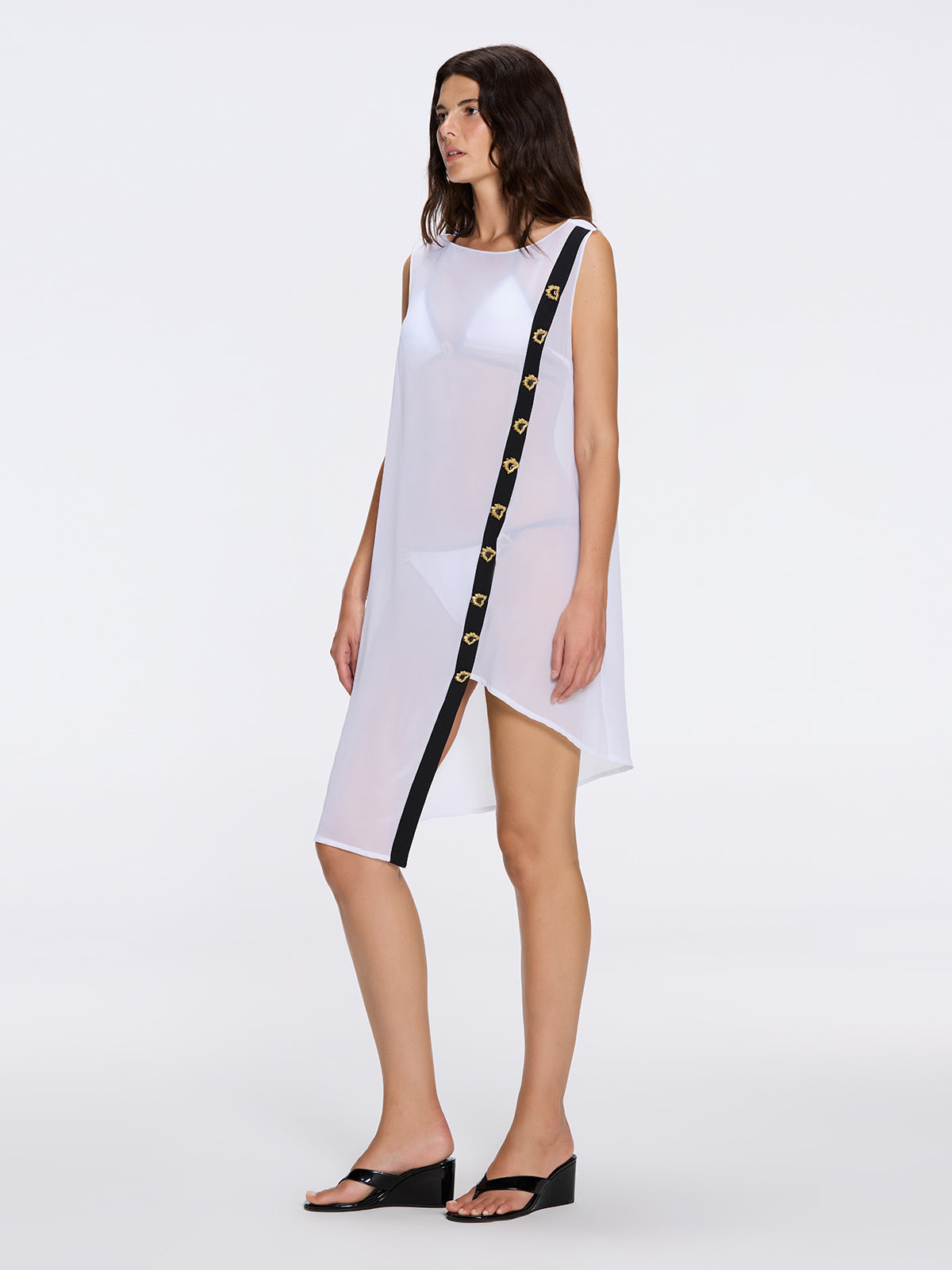 Solianne White Sheer Sleeveless Asymmetric Dress with Gold Button Detail | Moeva | Dress | Each week unveils new pieces—luxury swimwear, fluid resort silhouettes, and elevated summer-to-evening essentials designed to carry you from coastal escapes to city nights.