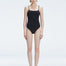 "Model wearing the Marigold Black Swimsuit from the Synersphere SS25 collection, with a square neckline and boned torso."
