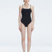 "Model wearing the Marigold Black Swimsuit from the Synersphere SS25 collection, with a square neckline and boned torso."
