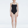 "Model wearing the Marigold Black Swimsuit from the Synersphere SS25 collection, with a square neckline and boned torso."
