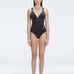 Front view of model wearing Marina Degraded Black One Piece swimsuit with halter neck and ruched waist detail.
