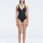 Front view of model wearing Marina Degraded Black One Piece swimsuit with halter neck and ruched waist detail.
