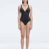 Front view of model wearing Marina Degraded Black One Piece swimsuit with halter neck and ruched waist detail.
