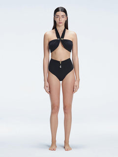 "Model wearing the Meredith Black Halter Neck Bikini Top with buckle detail and removable padding, standing by the pool."
