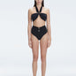 "Model wearing the Meredith Black Halter Neck Bikini Set with buckle detail and removable padding.
