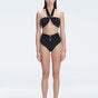 "Model wearing the Meredith Black Halter Neck Bikini Set with buckle detail and removable padding.
