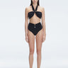 "Model wearing the Meredith Black Halter Neck Bikini Set with buckle detail and removable padding.
