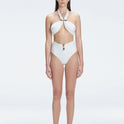 "Model wearing the Meredith White Halter Neck Bikini Bottom with buckle detail and removable padding, standing by the pool."
