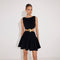 Lanao Black Cut-Out Knit Mini Dress with Gold Detail | Moeva | RTW Dresses | Each week unveils new pieces—luxury swimwear, fluid resort silhouettes, and elevated summer-to-evening essentials designed to carry you from coastal escapes to city nights.
