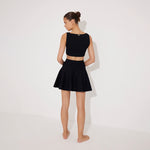 Lanao Black Cut-Out Knit Mini Dress with Gold Detail | Moeva | RTW Dresses | Each week unveils new pieces—luxury swimwear, fluid resort silhouettes, and elevated summer-to-evening essentials designed to carry you from coastal escapes to city nights.