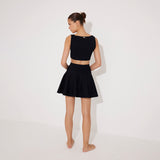 Lanao Black Cut-Out Knit Mini Dress with Gold Detail | Moeva | RTW Dresses | Each week unveils new pieces—luxury swimwear, fluid resort silhouettes, and elevated summer-to-evening essentials designed to carry you from coastal escapes to city nights.
