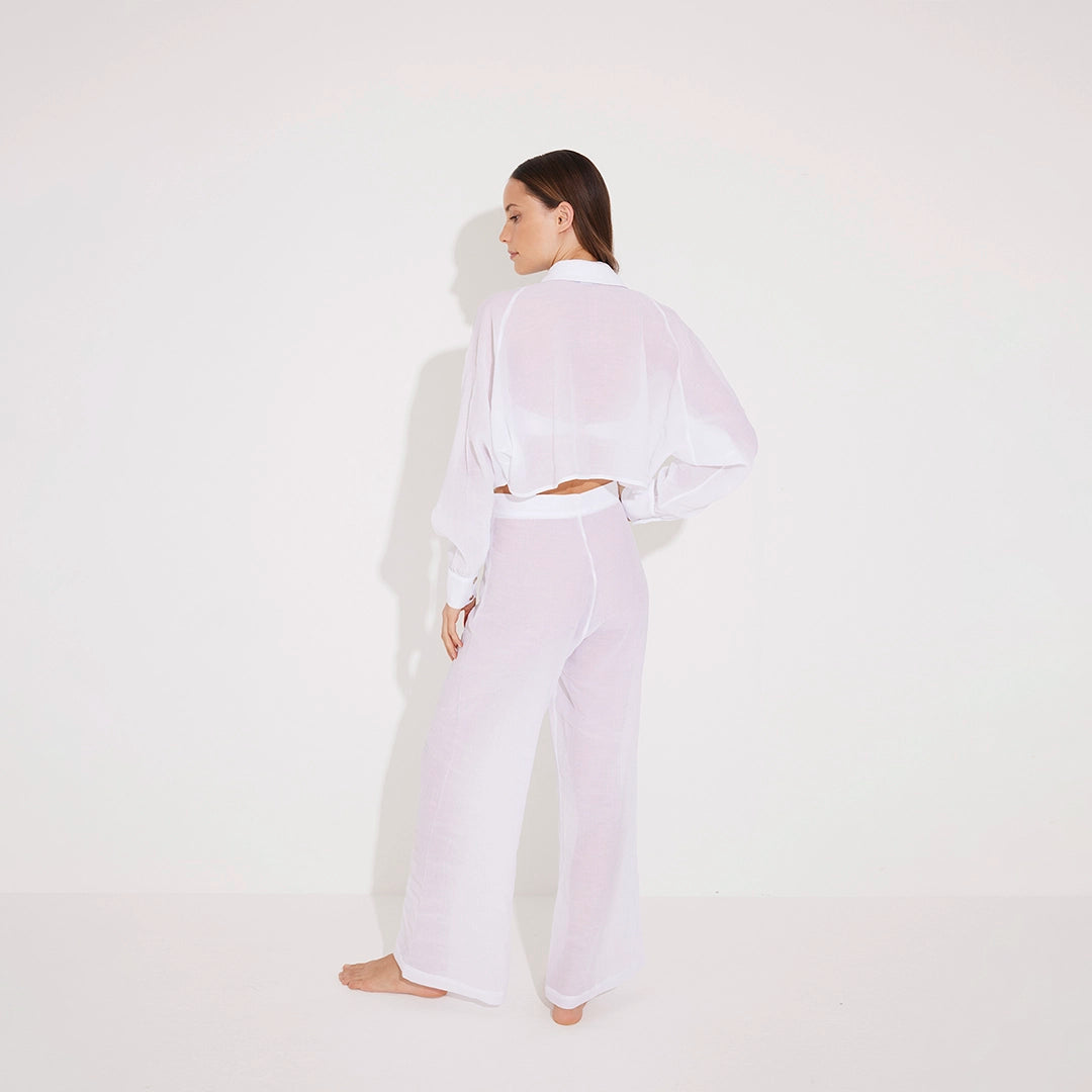 Jacinta White Cropped Sheer Long Sleeve Shirt and Aura White High Waist Beach Pants | Moeva | Shirt and Pants | Each week unveils new pieces—luxury swimwear, fluid resort silhouettes, and elevated summer-to-evening essentials designed to carry you from coastal escapes to city nights.