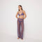 Luz Lilac Metallic Sheer Knit Pants | Moeva | Women Beachwear Pants | Each week unveils new pieces—luxury swimwear, fluid resort silhouettes, and elevated summer-to-evening essentials designed to carry you from coastal escapes to city nights.