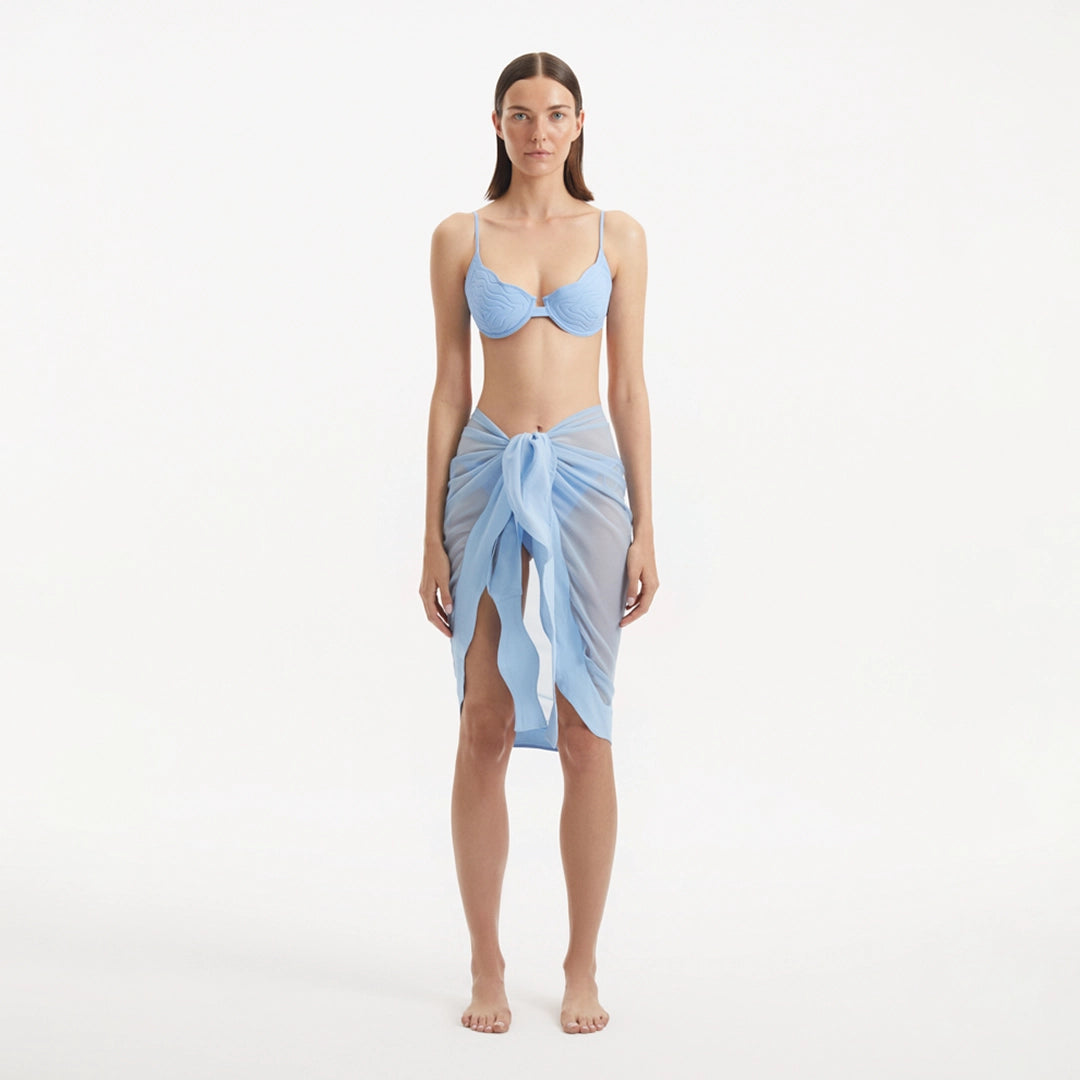 Raiden Baby Blue Tie Front Wavy-Trim Sheer Sarong | Moeva | Sarongs | Each week unveils new pieces—luxury swimwear, fluid resort silhouettes, and elevated summer-to-evening essentials designed to carry you from coastal escapes to city nights.