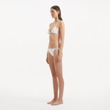Sarita White Triangle Wave Textured Side Tie Bikini Set | Moeva | | Each week unveils new pieces—luxury swimwear, fluid resort silhouettes, and elevated summer-to-evening essentials designed to carry you from coastal escapes to city nights.