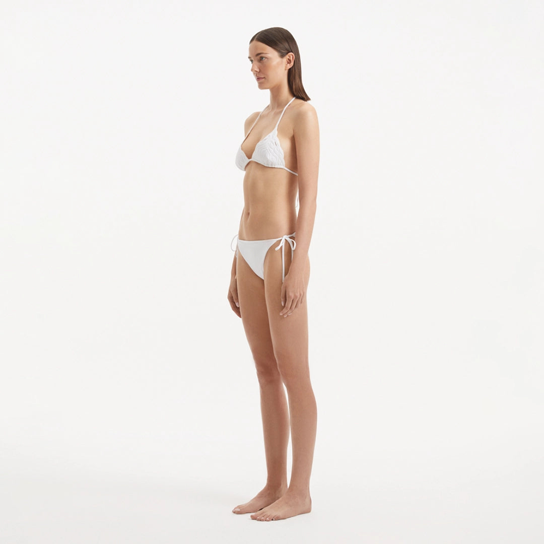 Sarita White Triangle Wave Textured Side Tie Bikini Set | Moeva | Bikini Set | Each week unveils new pieces—luxury swimwear, fluid resort silhouettes, and elevated summer-to-evening essentials designed to carry you from coastal escapes to city nights.