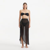 Xander Black Sheer Maxi Skirt with Gold Button Details | Moeva | Beachwear Skirts | Each week unveils new pieces—luxury swimwear, fluid resort silhouettes, and elevated summer-to-evening essentials designed to carry you from coastal escapes to city nights.