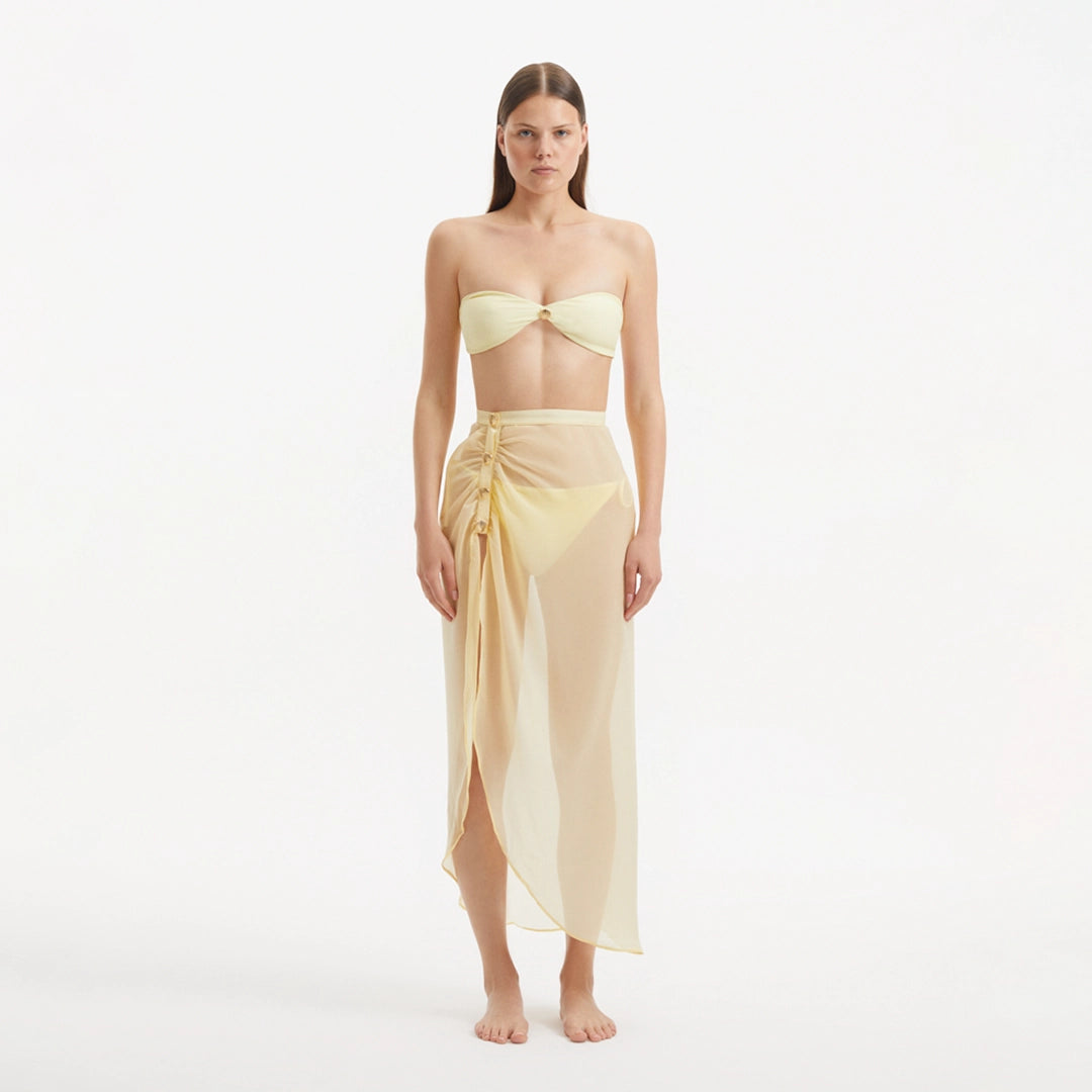Xander Yellow Sheer Maxi Skirt with Gold Button Details | Moeva | Beachwear Skirts | Each week unveils new pieces—luxury swimwear, fluid resort silhouettes, and elevated summer-to-evening essentials designed to carry you from coastal escapes to city nights.