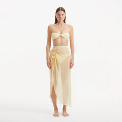 Xander Yellow Sheer Maxi Skirt with Gold Button Details | Moeva | Beachwear Skirts | Each week unveils new pieces—luxury swimwear, fluid resort silhouettes, and elevated summer-to-evening essentials designed to carry you from coastal escapes to city nights.
