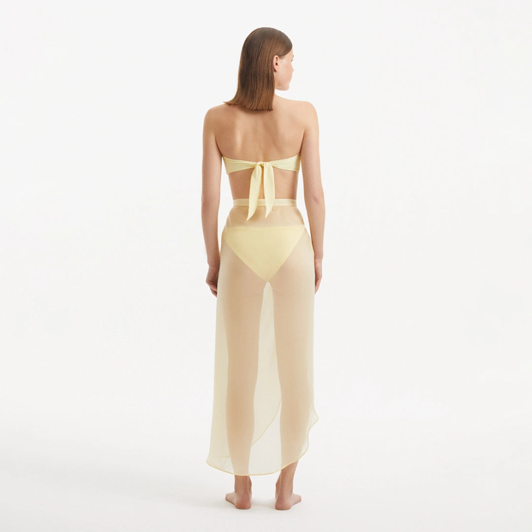 Xander Yellow Sheer Maxi Skirt with Gold Button Details | Moeva | Beachwear Skirts | Each week unveils new pieces—luxury swimwear, fluid resort silhouettes, and elevated summer-to-evening essentials designed to carry you from coastal escapes to city nights.