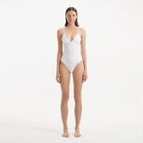 Anahita White V Neck Swimsuit | Moeva | Swimsuit | Each week unveils new pieces—luxury swimwear, fluid resort silhouettes, and elevated summer-to-evening essentials designed to carry you from coastal escapes to city nights.