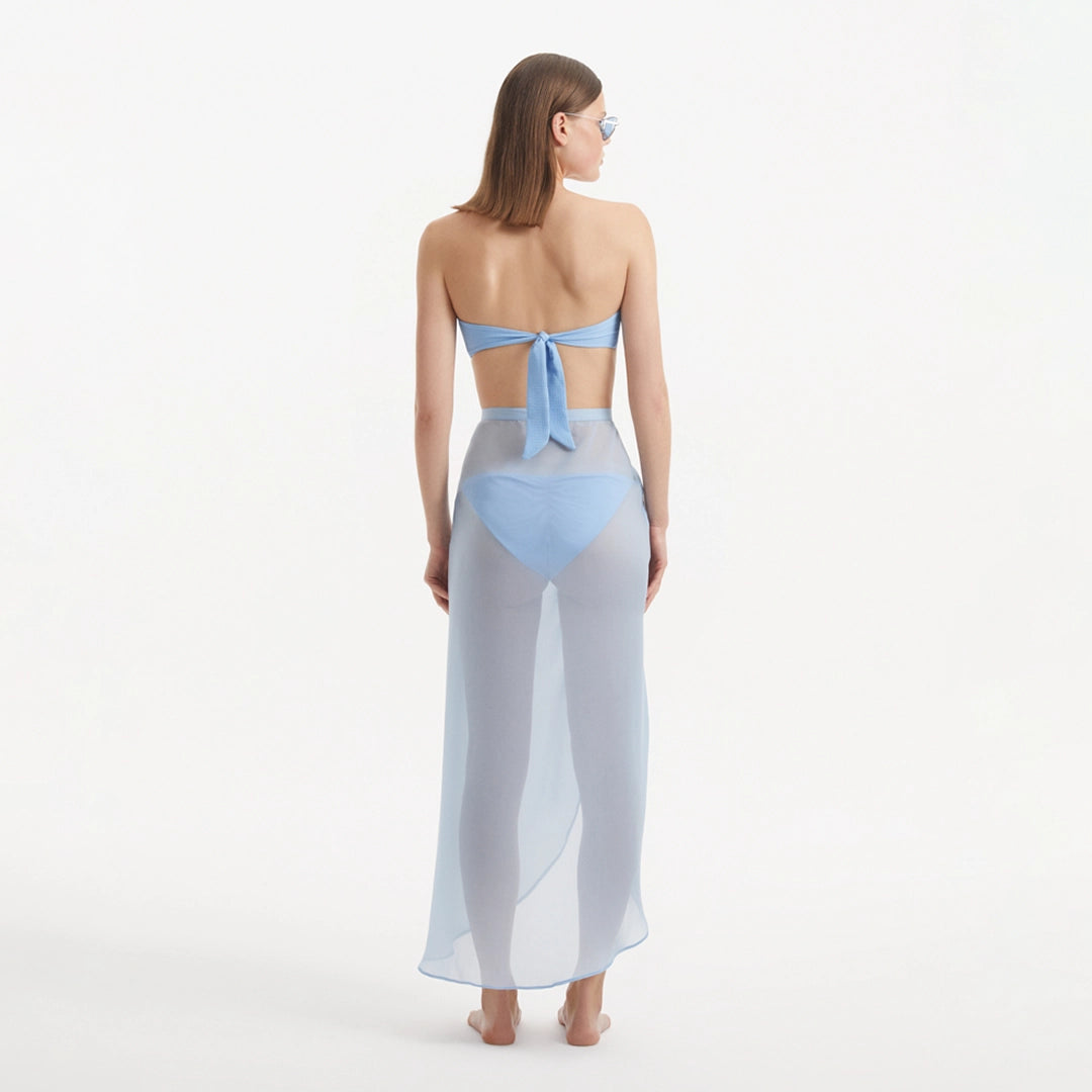 Xander Baby Blue Sheer Maxi Skirt with Gold Button Details | Moeva | Beachwear Skirts | Each week unveils new pieces—luxury swimwear, fluid resort silhouettes, and elevated summer-to-evening essentials designed to carry you from coastal escapes to city nights.