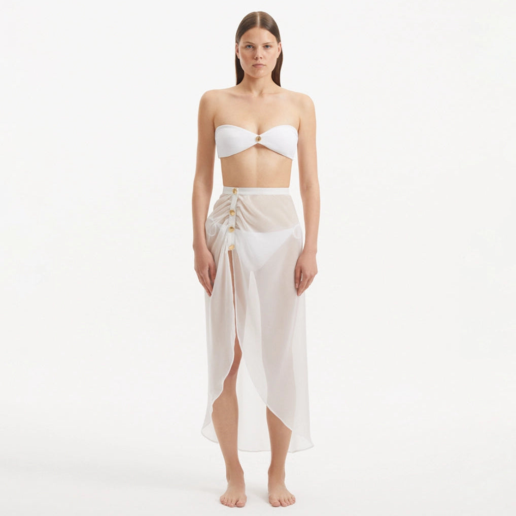 Xander White Sheer Maxi Skirt with Gold Button Details | Moeva | Skirt | Each week unveils new pieces—luxury swimwear, fluid resort silhouettes, and elevated summer-to-evening essentials designed to carry you from coastal escapes to city nights.