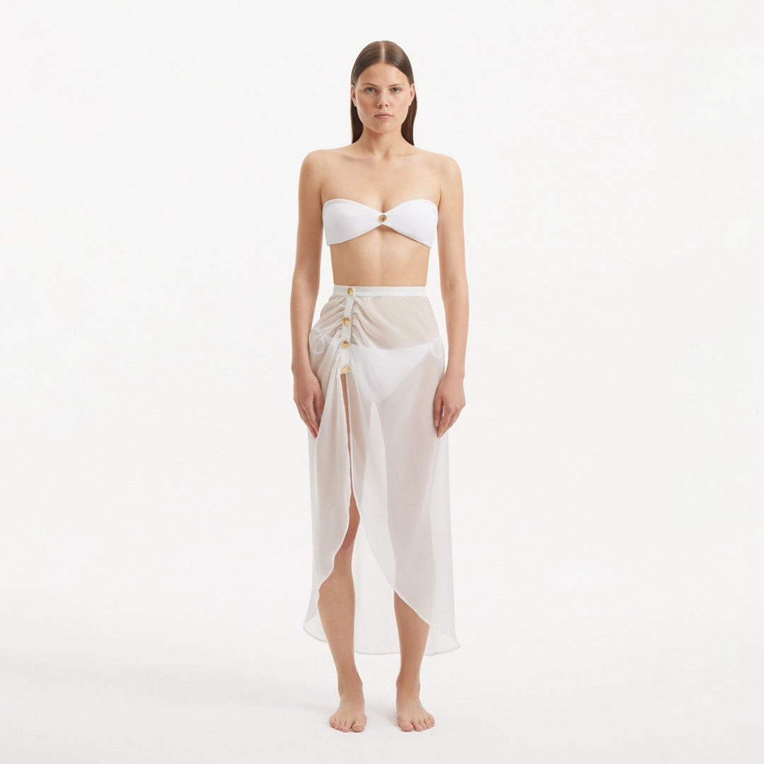 Xander White Sheer Maxi Skirt with Gold Button Details | Moeva | Beachwear Skirts | Each week unveils new pieces—luxury swimwear, fluid resort silhouettes, and elevated summer-to-evening essentials designed to carry you from coastal escapes to city nights.