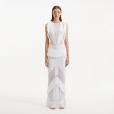 Maris White Knitted Maxi Dress with Fringe and Open Back | Moeva | RTW Dresses | Each week unveils new pieces—luxury swimwear, fluid resort silhouettes, and elevated summer-to-evening essentials designed to carry you from coastal escapes to city nights.