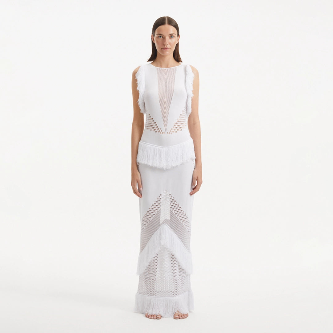 Maris White Knitted Maxi Dress with Fringe and Open Back | Moeva | RTW Dresses | Each week unveils new pieces—luxury swimwear, fluid resort silhouettes, and elevated summer-to-evening essentials designed to carry you from coastal escapes to city nights.