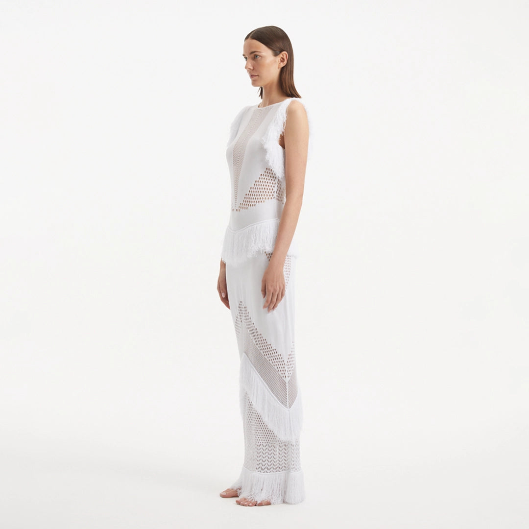 Maris White Knitted Maxi Dress with Fringe and Open Back | Moeva | RTW Dresses | Each week unveils new pieces—luxury swimwear, fluid resort silhouettes, and elevated summer-to-evening essentials designed to carry you from coastal escapes to city nights.