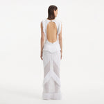 Maris White Knitted Maxi Dress with Fringe and Open Back | Moeva | RTW Dresses | Each week unveils new pieces—luxury swimwear, fluid resort silhouettes, and elevated summer-to-evening essentials designed to carry you from coastal escapes to city nights.