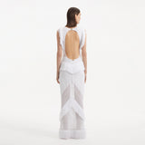 Maris White Knitted Maxi Dress with Fringe and Open Back | Moeva | RTW Dresses | Each week unveils new pieces—luxury swimwear, fluid resort silhouettes, and elevated summer-to-evening essentials designed to carry you from coastal escapes to city nights.
