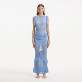 Maris Baby Blue Knitted Maxi Dress with Fringe and Open Back | Moeva | RTW Dresses | Each week unveils new pieces—luxury swimwear, fluid resort silhouettes, and elevated summer-to-evening essentials designed to carry you from coastal escapes to city nights.