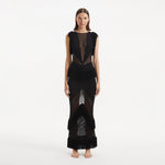 Maris Black Knitted Maxi Dress with Fringe and Open Back | Moeva | RTW Dresses | Each week unveils new pieces—luxury swimwear, fluid resort silhouettes, and elevated summer-to-evening essentials designed to carry you from coastal escapes to city nights.