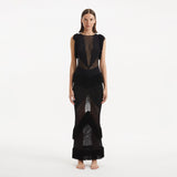 Maris Black Knitted Maxi Dress with Fringe and Open Back | Moeva | RTW Dresses | Each week unveils new pieces—luxury swimwear, fluid resort silhouettes, and elevated summer-to-evening essentials designed to carry you from coastal escapes to city nights.