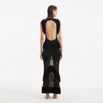 Maris Black Knitted Maxi Dress with Fringe and Open Back | Moeva | RTW Dresses | Each week unveils new pieces—luxury swimwear, fluid resort silhouettes, and elevated summer-to-evening essentials designed to carry you from coastal escapes to city nights.
