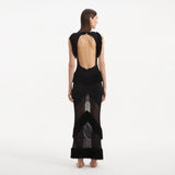 Maris Black Knitted Maxi Dress with Fringe and Open Back | Moeva | RTW Dresses | Each week unveils new pieces—luxury swimwear, fluid resort silhouettes, and elevated summer-to-evening essentials designed to carry you from coastal escapes to city nights.