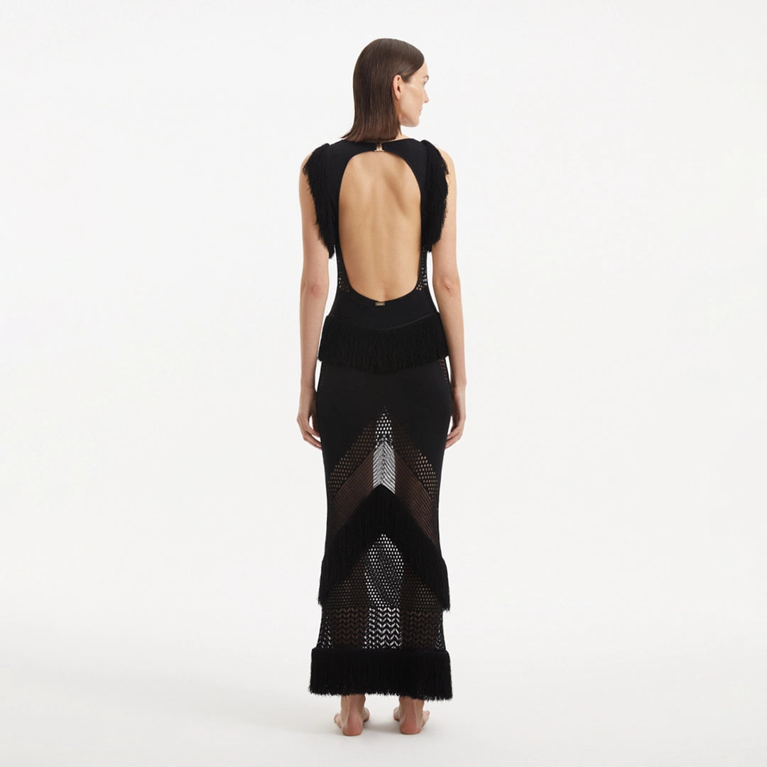 Maris Black Knitted Maxi Dress with Fringe and Open Back | Moeva | RTW Dresses | Each week unveils new pieces—luxury swimwear, fluid resort silhouettes, and elevated summer-to-evening essentials designed to carry you from coastal escapes to city nights.