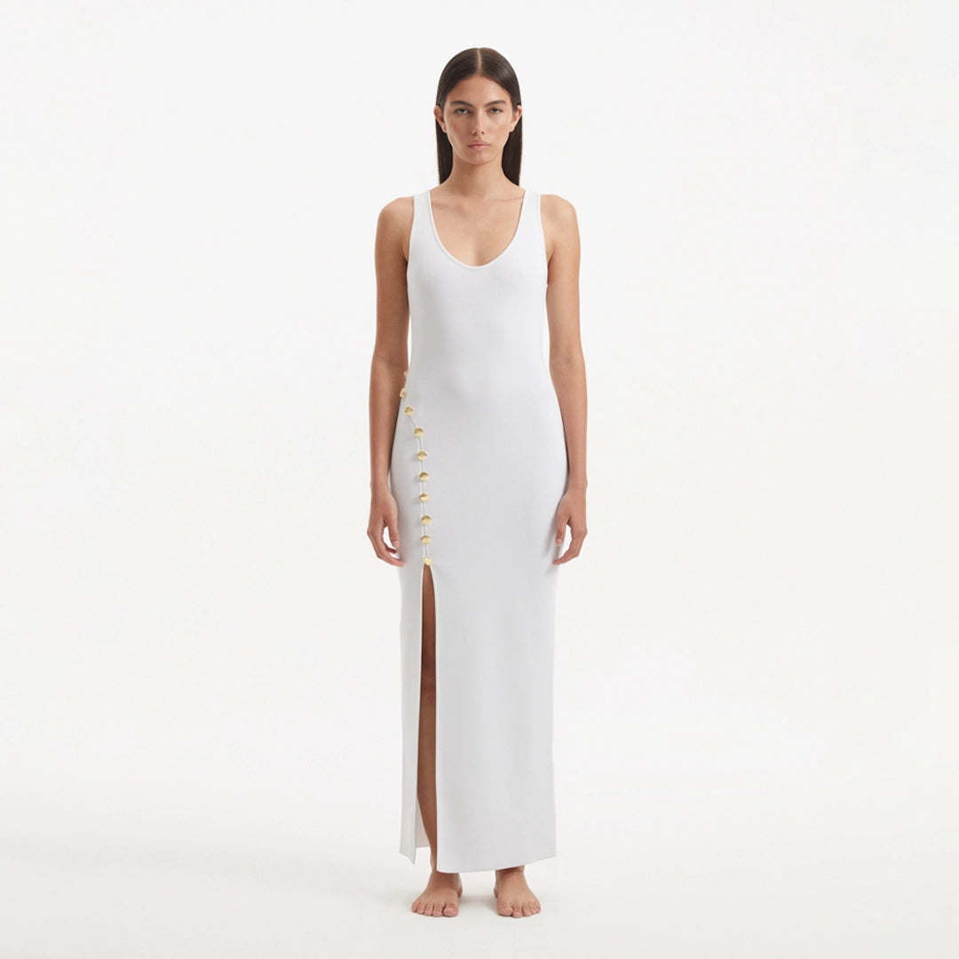 Raine White Knit Maxi Dress with Side Slit & Button Detail | Moeva | RTW Dresses | Each week unveils new pieces—luxury swimwear, fluid resort silhouettes, and elevated summer-to-evening essentials designed to carry you from coastal escapes to city nights.