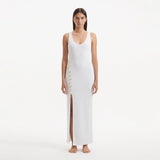 Raine White Knit Maxi Dress with Side Slit & Button Detail | Moeva | RTW Dresses | Each week unveils new pieces—luxury swimwear, fluid resort silhouettes, and elevated summer-to-evening essentials designed to carry you from coastal escapes to city nights.