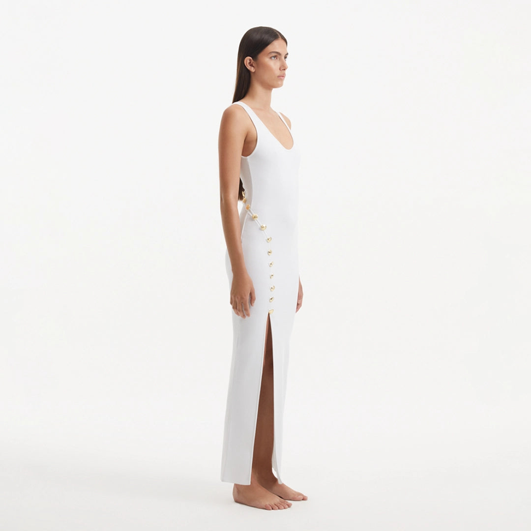 Raine White Knit Maxi Dress with Side Slit & Button Detail | Moeva | RTW Dresses | Each week unveils new pieces—luxury swimwear, fluid resort silhouettes, and elevated summer-to-evening essentials designed to carry you from coastal escapes to city nights.